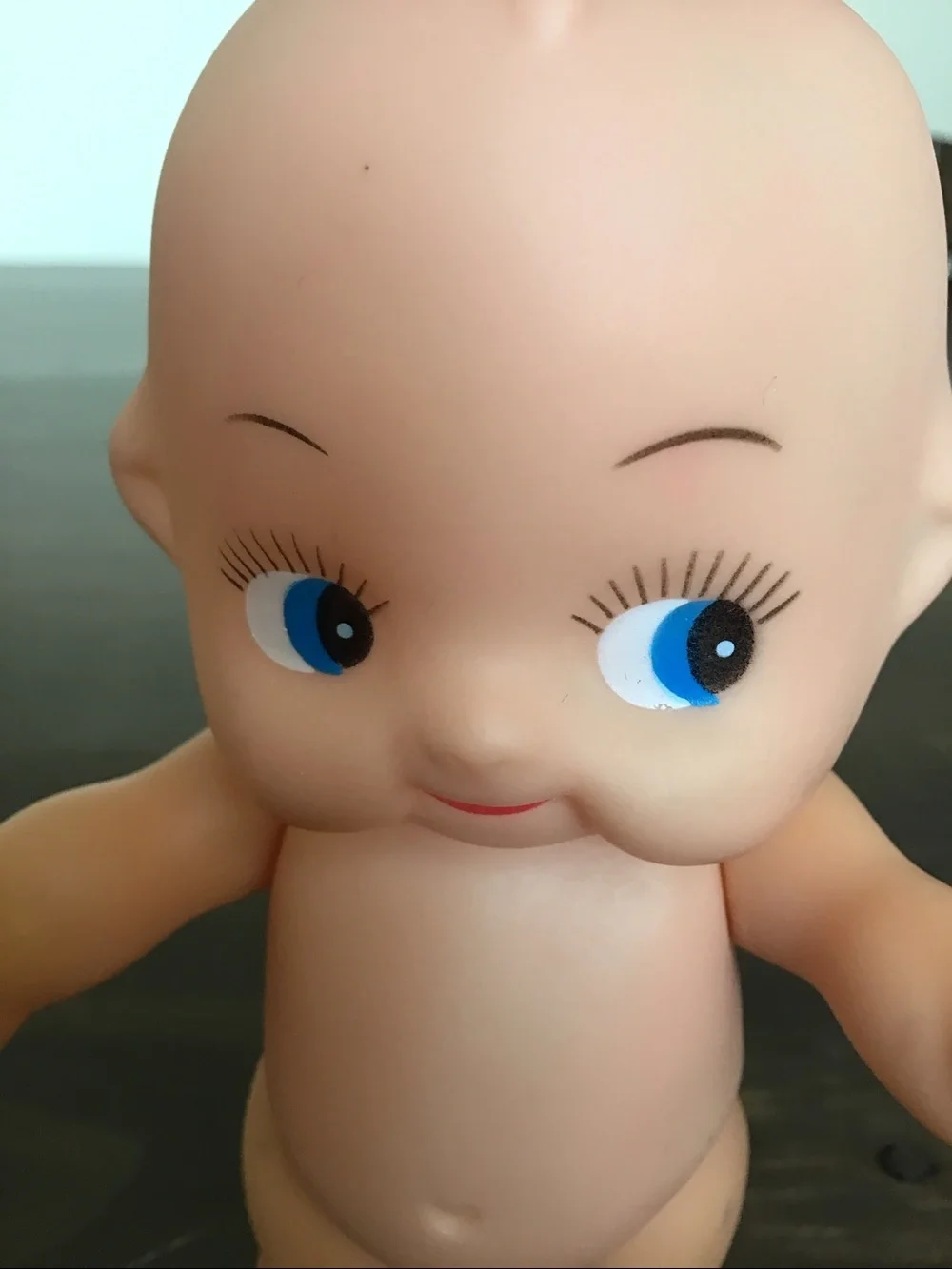 Vintage unmarked 6-inch hard plastic Kewpie doll from the mid-century era